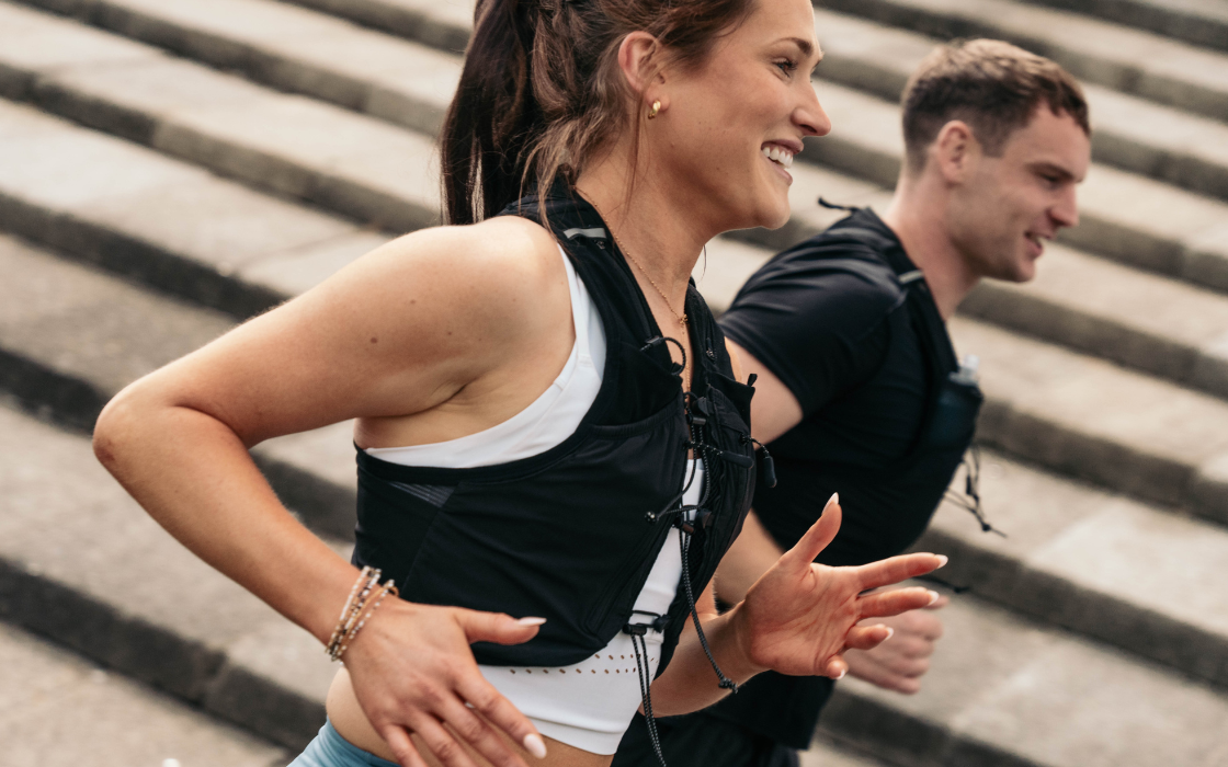 Woman running with in a running vest